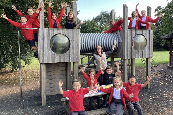 CROSSWAYS Federation head teacher Jo Geoghegan celebrates with children after inspectors from Ofsted praised the junior school's high aspirations, ambitious curriculum and well-behaved pupils.