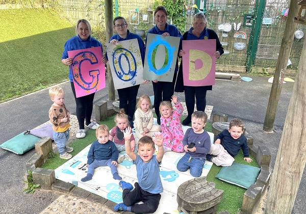 Staff and children at Happy Days Nursery in Thornbury spell out their 'good' Ofsted rating