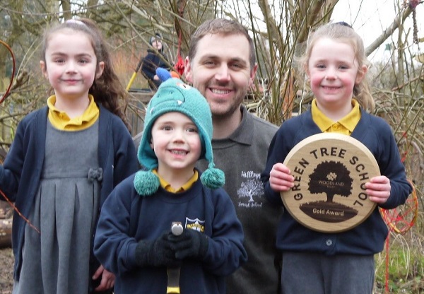 Forest school leader Alex Hill with Olveston Primary School pupils and the award